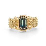 An 18ct gold chainmaille ring featuring a large natural Australian blue and yellow parti sapphire centrepiece, surrounded by a chain link chainmail band with white gold accents. by Corrinne Eira Evans