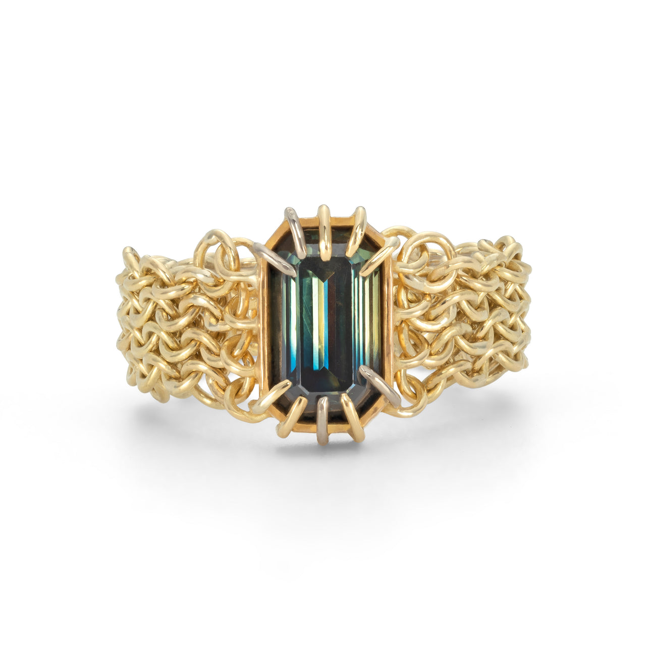 A gold ring featuring a large blue and yellow parti sapphire centrepiece, surrounded by a chain link chainmail band with white gold accents. by Corrinne Eira Evans