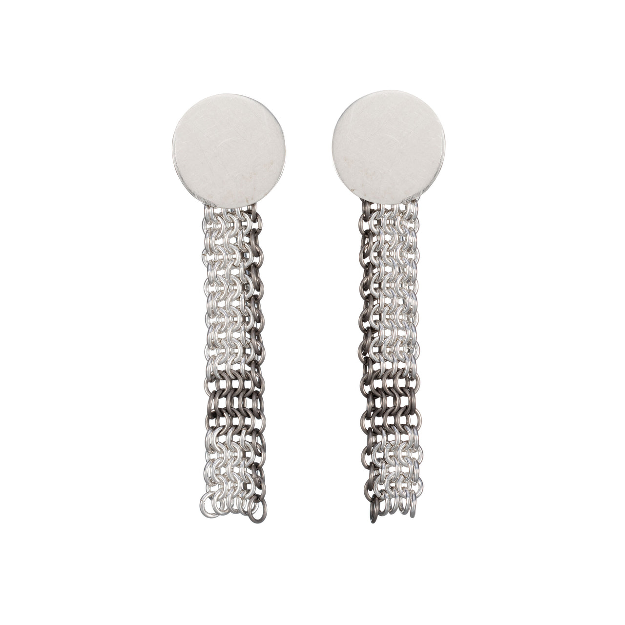 A pair of silver chainmail earrings with a flat circular design at the ear lobe and flowing down with handcrafted links, displayed against a white background.